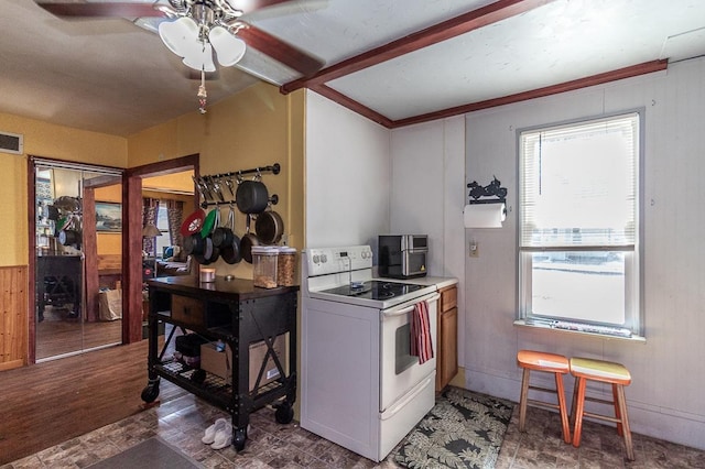 kitchen featuring a ceiling fan, baseboards, visible vents, beam ceiling, and electric stove