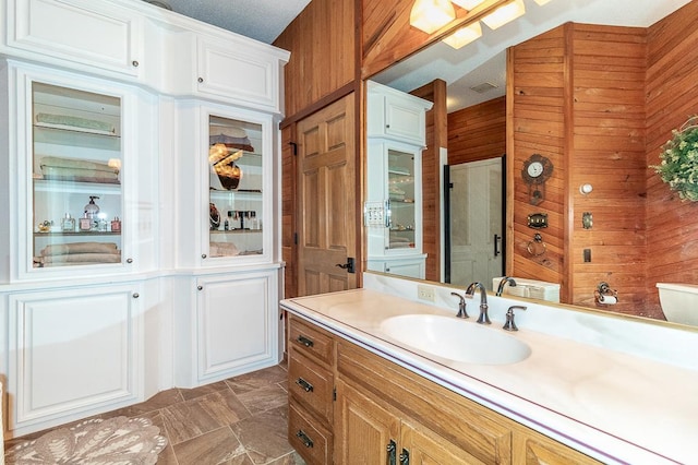 full bathroom with wood walls and vanity