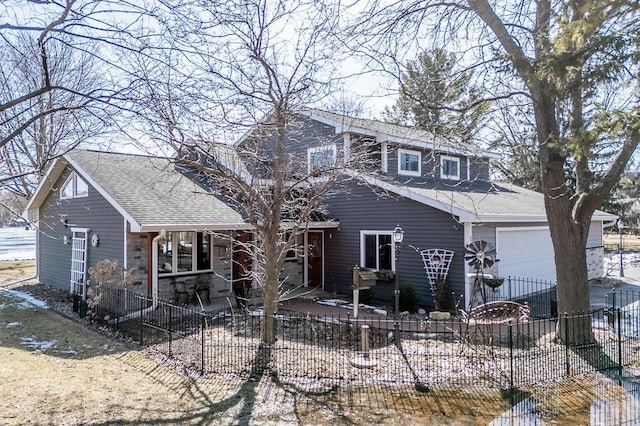 view of front of property featuring a garage, a patio area, a shingled roof, and fence