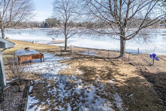 snowy yard with fence