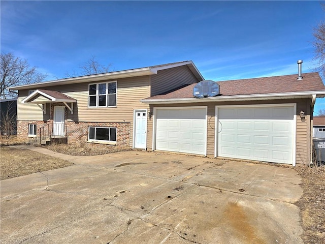 view of front of house featuring an attached garage, brick siding, and driveway