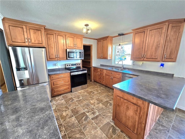 kitchen with dark countertops, appliances with stainless steel finishes, and brown cabinetry