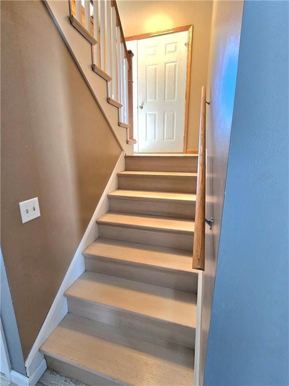 staircase featuring baseboards