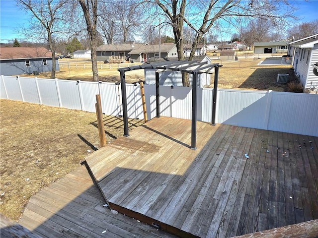 deck with fence, a residential view, and central AC