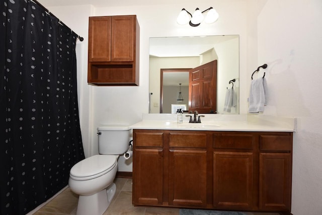 bathroom with toilet, curtained shower, tile patterned flooring, baseboards, and vanity