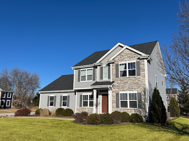 view of front of home featuring stone siding and a front yard