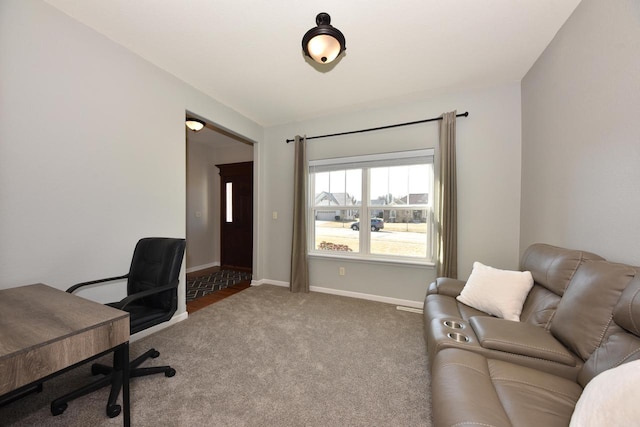 carpeted home office featuring baseboards