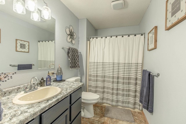 full bath with a shower with shower curtain, toilet, vanity, and a textured ceiling