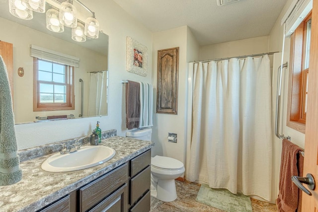 bathroom featuring curtained shower, toilet, and vanity