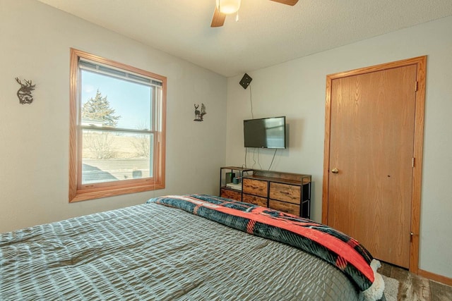 bedroom featuring wood finished floors and a ceiling fan