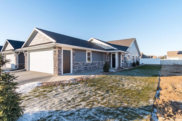 single story home with a garage, stone siding, a front lawn, and fence