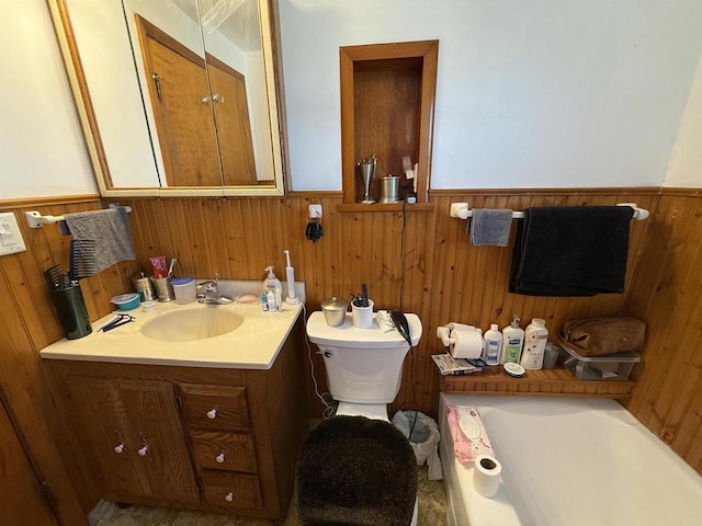 bathroom featuring vanity, toilet, wood walls, and wainscoting