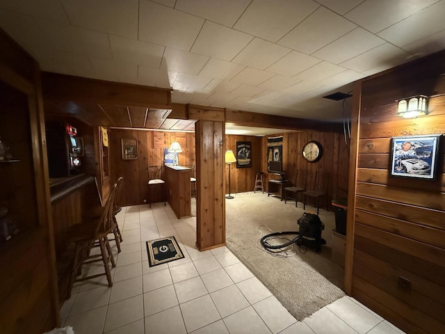 interior space featuring wood walls and light colored carpet