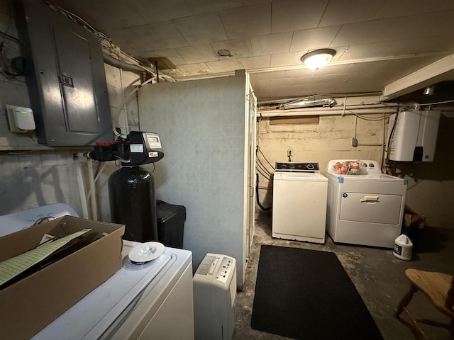 clothes washing area featuring washing machine and clothes dryer, laundry area, water heater, and electric panel