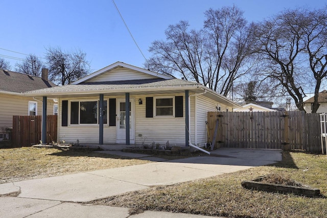 bungalow featuring covered porch and fence