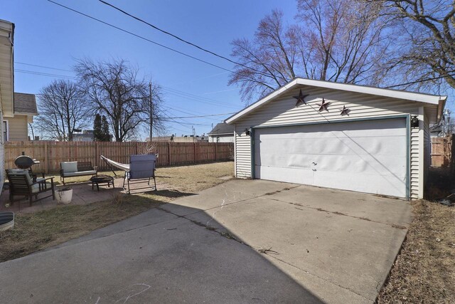 detached garage featuring fence