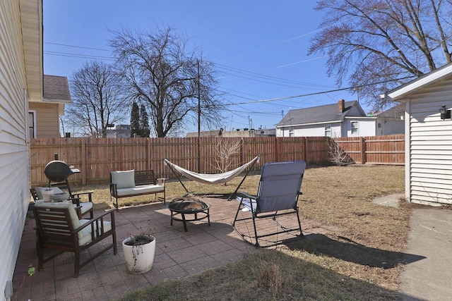 view of patio / terrace with a fenced backyard and a fire pit