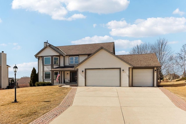 traditional home featuring a front lawn, an attached garage, and concrete driveway