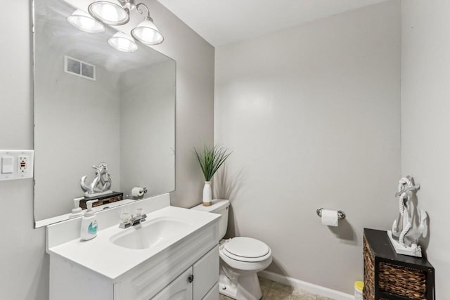 half bathroom with visible vents, baseboards, toilet, tile patterned floors, and vanity