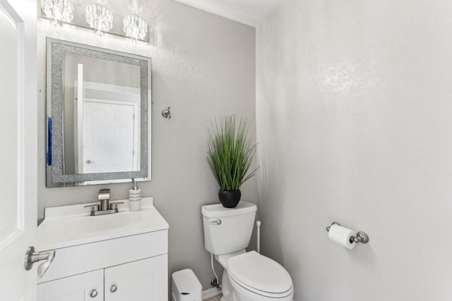 half bathroom featuring toilet and vanity