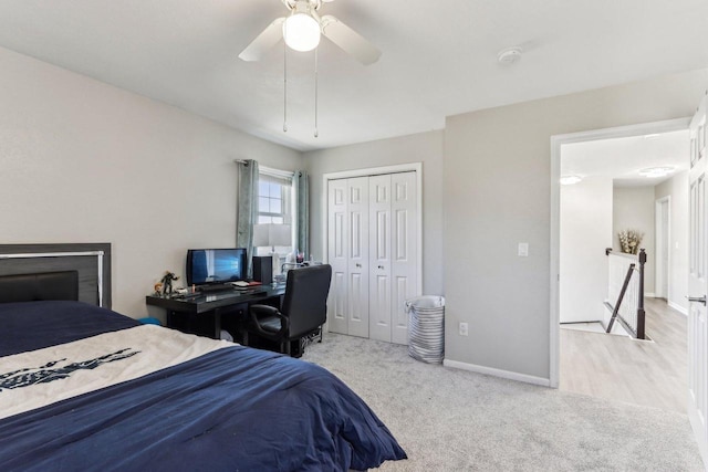 carpeted bedroom featuring a closet, baseboards, and ceiling fan