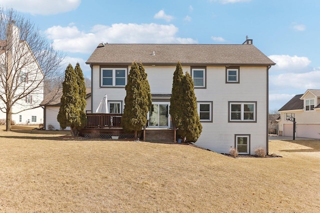 rear view of property featuring a lawn and a wooden deck