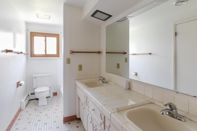 full bath featuring double vanity, toilet, a baseboard radiator, and a sink