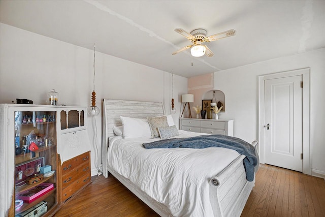 bedroom featuring wood-type flooring and ceiling fan