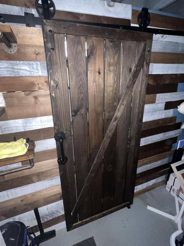 interior space with a barn door and concrete floors