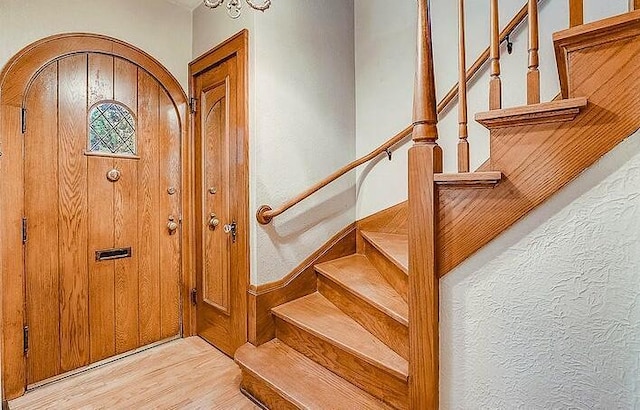 interior space featuring wood finished floors and arched walkways