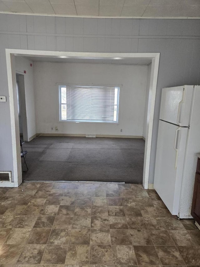 1638 Taylor Ave, Racine, WI 53403 - spare room with dark colored carpet, visible vents, and wood walls