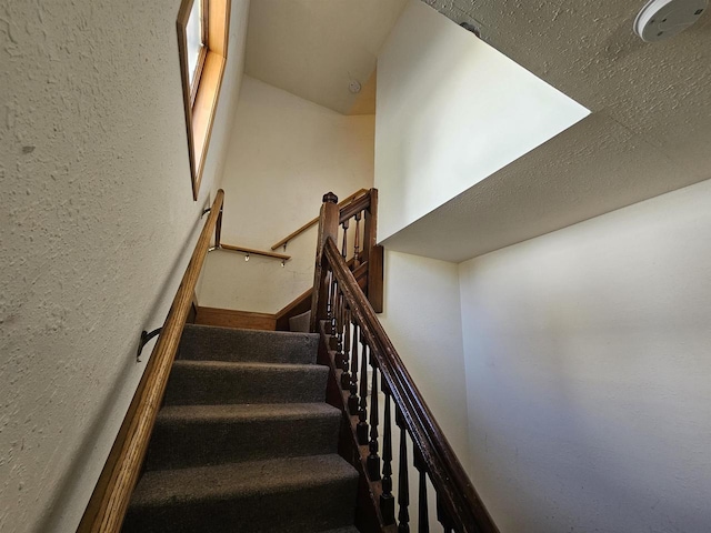 staircase with a textured wall