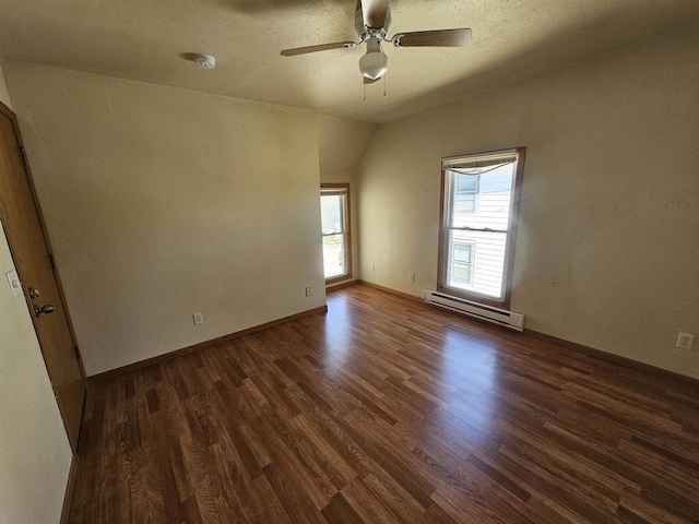 spare room featuring dark wood finished floors, baseboards, ceiling fan, and a baseboard radiator