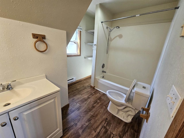 full bathroom featuring a baseboard heating unit, washtub / shower combination, vanity, toilet, and wood finished floors