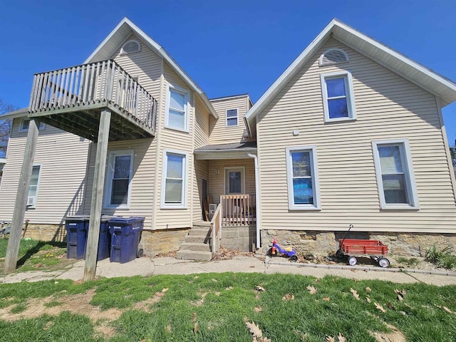 back of property featuring a balcony