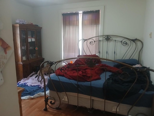 bedroom with wood finished floors