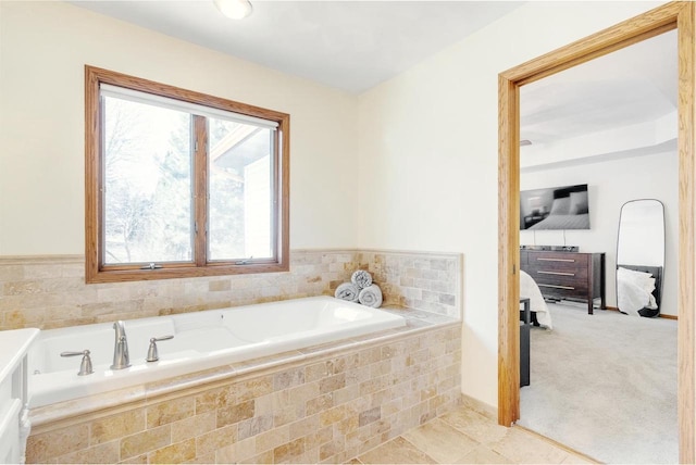 bathroom featuring tile patterned floors, ensuite bath, and a garden tub