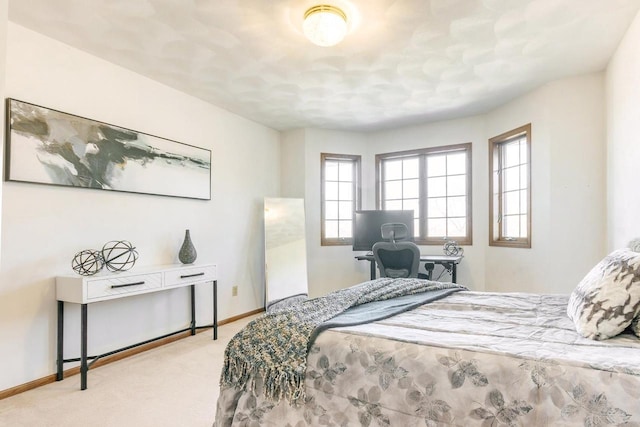 bedroom featuring carpet flooring and baseboards