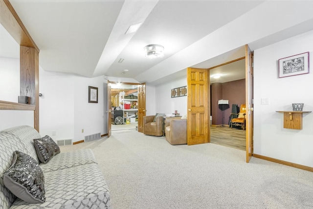 living room with carpet flooring, baseboards, and visible vents