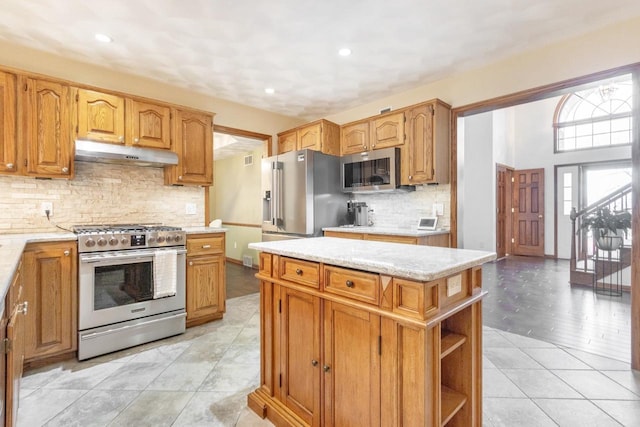 kitchen featuring under cabinet range hood, open shelves, backsplash, stainless steel appliances, and light tile patterned flooring