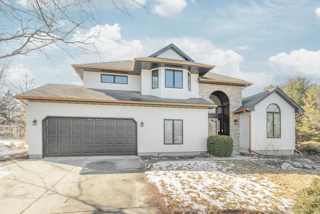 view of front of property featuring concrete driveway and a garage