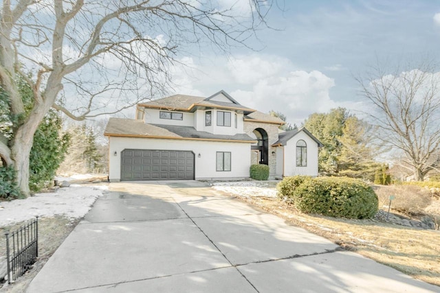 view of front of property featuring concrete driveway and fence