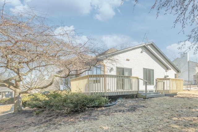 back of house featuring a deck