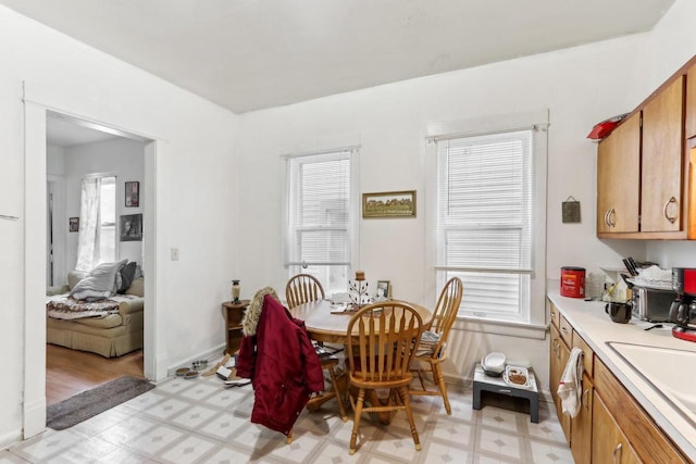 dining area with light floors and baseboards