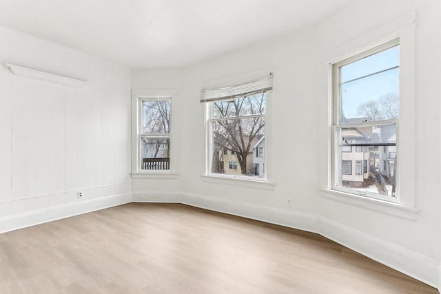 empty room with baseboards and wood finished floors