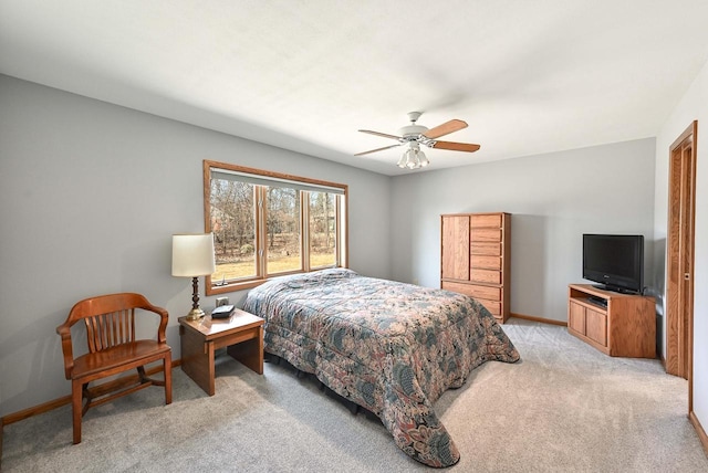 bedroom with ceiling fan, baseboards, and light carpet