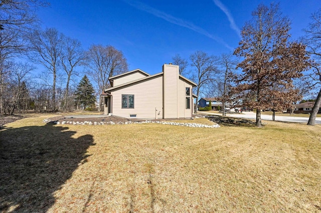 view of property exterior with a yard and a chimney