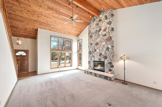 unfurnished living room with a stone fireplace, wooden ceiling, high vaulted ceiling, and carpet