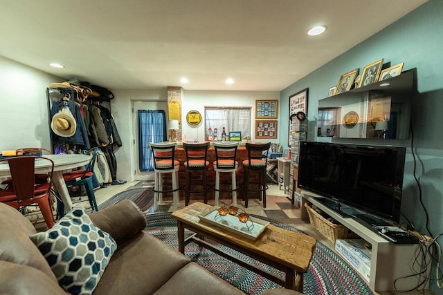 living area featuring recessed lighting and a bar