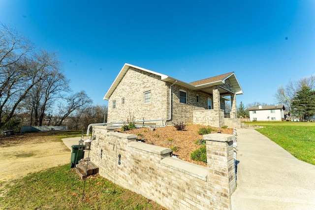 view of side of home featuring a lawn